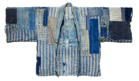 MEIJI PERIOD (1868–1912) JAPANESE FARMER'S COAT, INDIGO-DYED COTTON SCRAPS WITH SASHIKO STITCHING. BORO TEXTILES WERE GARMENTS PATCHED AND REPAIRED OVER GENERATIONS THROUGH NECESSITY AND RESOURCEFULNESS. VIA SOTHEBY'S AUCTION.